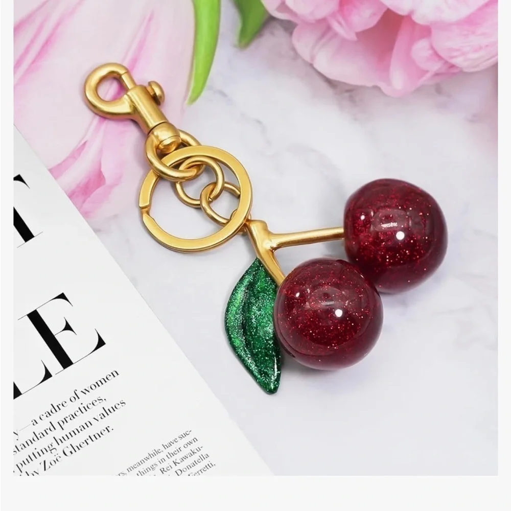 Cherry bag charm keychain with gold hardware clips onto your coach bag or ju…